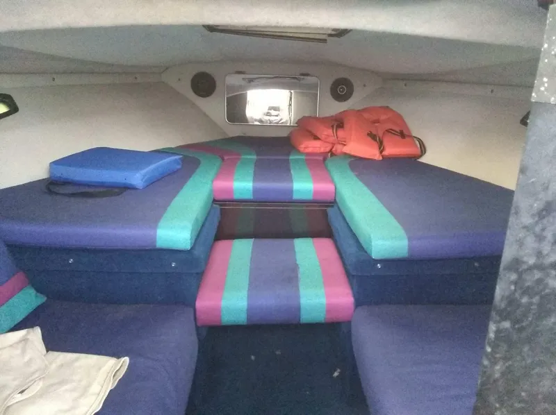 Slide: The Image of Interior cabin of 1988 Wellcraft 23 NOVA XL with colorful cushions and life jackets. - 7