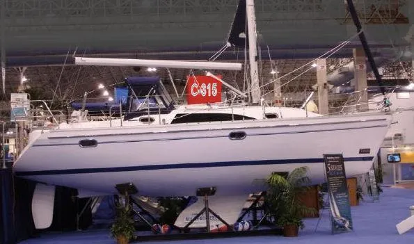 Slide: The Image of 2026 Catalina 316 sailboat displayed indoors at a boat show. - 9