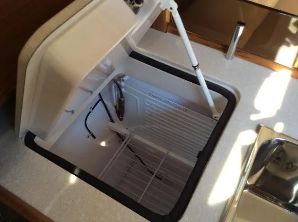Slide: The Image of Open storage compartment in Catalina 426 yacht, 2026 model, with white interior and metal hinge. - 14