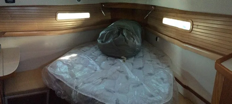 Slide: The Image of Cozy cabin interior of 2026 Catalina 426 sailboat with wooden accents and a bed. - 16