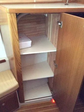 Slide: The Image of Open wooden cabinet with shelves inside a Catalina 426, 2026 model. - 19
