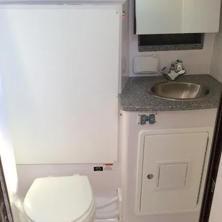 Slide: The Image of Compact bathroom in Catalina 426, featuring a toilet, sink, and storage, 2026 model. - 21