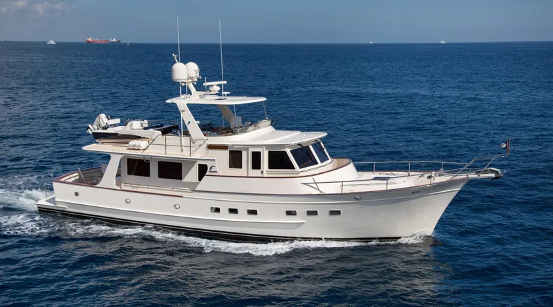 Slide: The Image of Luxurious 2027 Fleming 58 yacht cruising on open sea under clear skies. - 3