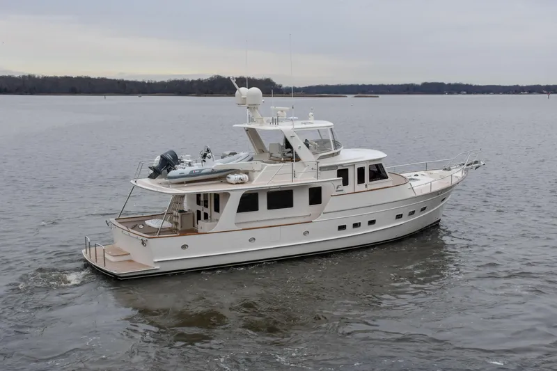 Slide: The Image of Luxurious 2027 Fleming 58 yacht cruising on a calm lake. - 4