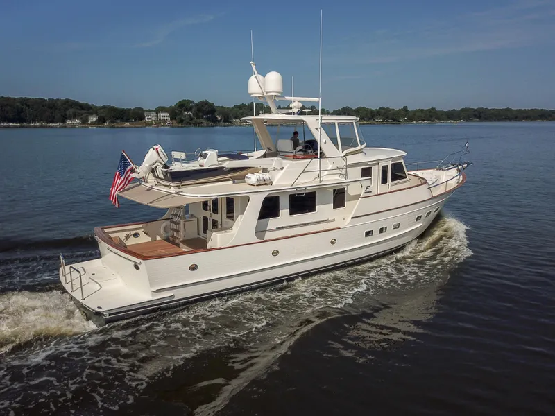 Slide: The Image of Luxury Fleming 58 yacht cruising on calm waters, 2027 model, elegant design. - 6