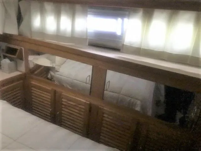 Slide: The Image of Interior cabin of a 1986 Silverton 40 Double Cabin yacht with wooden accents. - 12