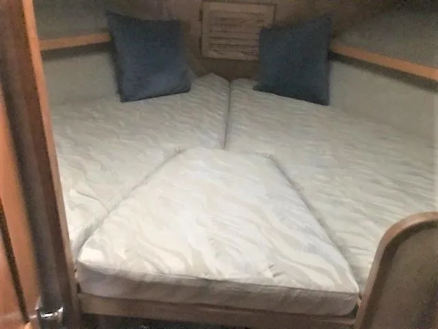 Slide: The Image of 1986 Silverton 40 Double Cabin interior with twin beds and blue pillows. - 14