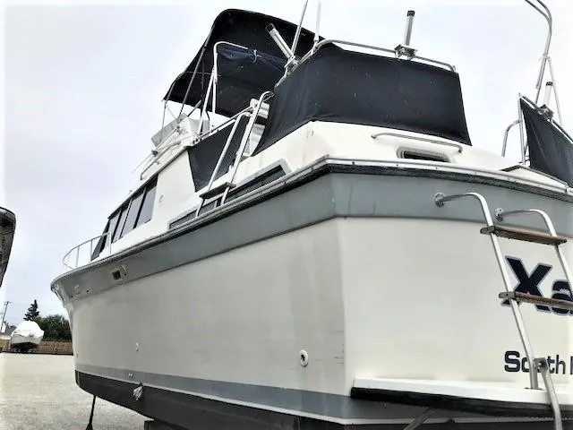 Slide: The Image of 1986 Silverton 40 Double Cabin boat with black canopy. - 3