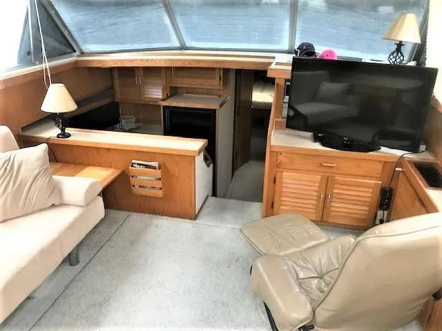Slide: The Image of Interior of 1986 Silverton 40 Double Cabin with TV, seating, and wooden cabinetry. - 8