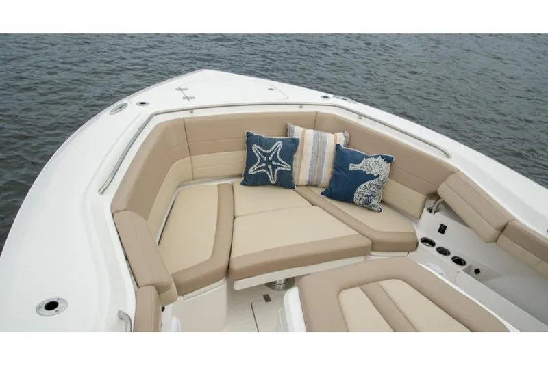 Slide: The Image of 2023 Sailfish 360 CC boat with beige seating and decorative pillows. - 10
