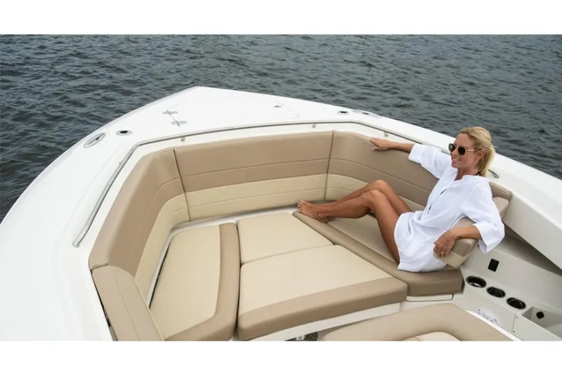 Slide: The Image of Woman relaxing on a 2023 Sailfish 360 CC boat with beige seating. - 11