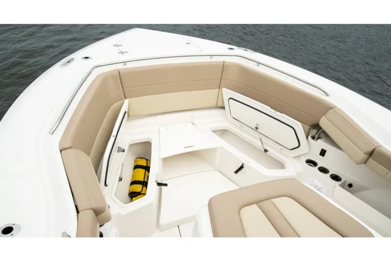 Slide: The Image of 2023 Sailfish 360 CC boat interior with beige seating and storage compartments. - 12