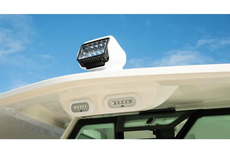 Slide: The Image of Close-up of 2023 Sailfish 360 CC boat's LED lights and radar against blue sky. - 16