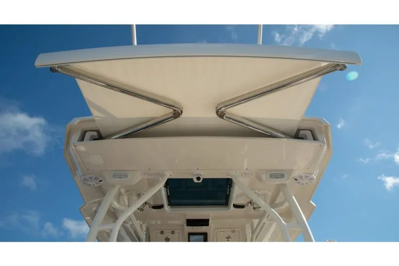 Slide: The Image of 2023 Sailfish 360 CC boat canopy and electronics against blue sky. - 18