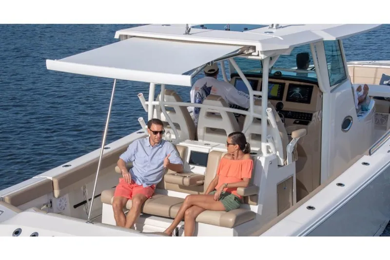 Slide: The Image of 2023 Sailfish 360 CC boat with passengers relaxing on deck. - 20