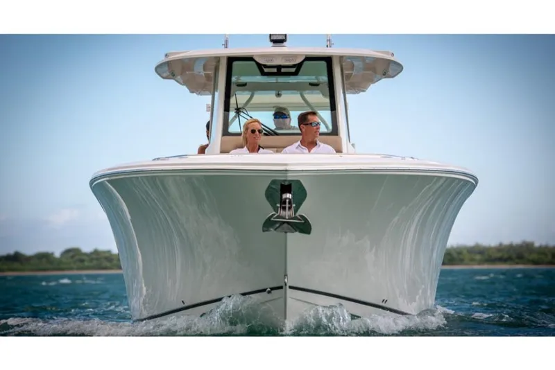 Slide: The Image of 2023 Sailfish 360 CC boat cruising on water, front view. - 21