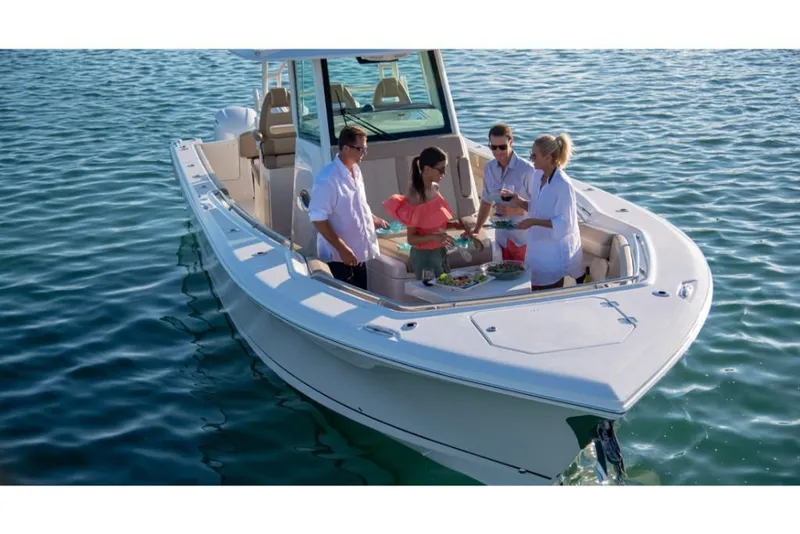 Slide: The Image of 2023 Sailfish 360 CC boat with people enjoying a meal on the water. - 22