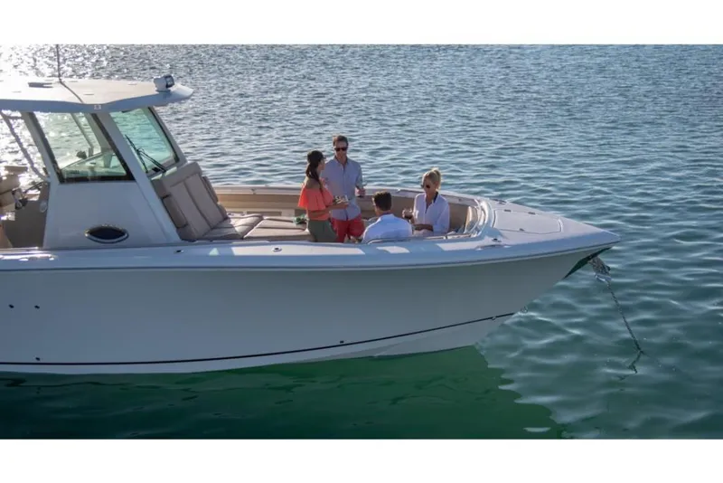 Slide: The Image of 2023 Sailfish 360 CC boat with people enjoying on deck in calm waters. - 23