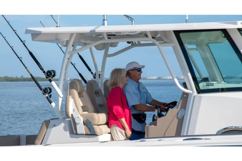 Slide: The Image of Couple enjoying a ride on a 2023 Sailfish 360 CC boat. - 29