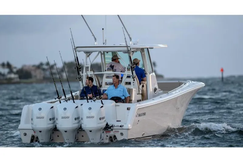 Slide: The Image of 2023 Sailfish 360 CC boat with triple outboard engines on the water. - 3