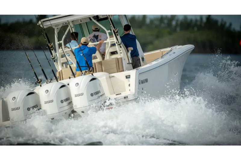 Slide: The Image of 2023 Sailfish 360 CC boat with triple Yamaha engines on the water. - 7
