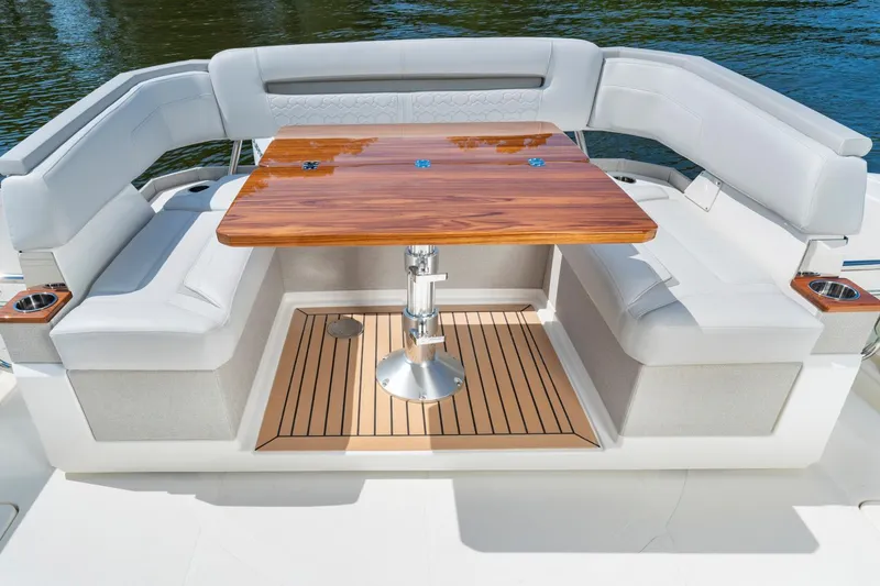 Slide: The Image of 2025 Tiara Sport 38 LS boat with luxurious seating and wooden table. - 10