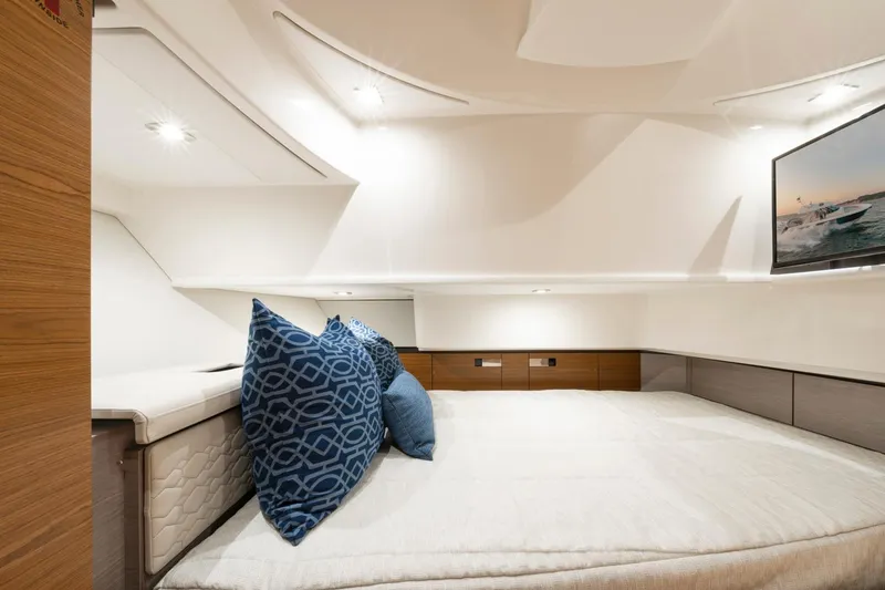 Slide: The Image of Luxurious cabin interior of 2025 Tiara Sport 38 LS yacht with plush bedding and modern decor. - 25