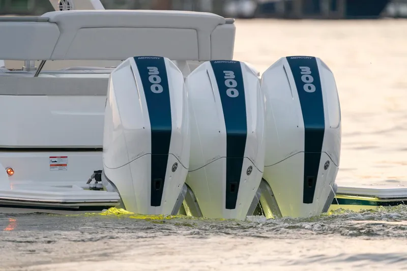 Slide: The Image of Triple outboard engines on a 2025 Tiara Sport 38 LS boat in water. - 27