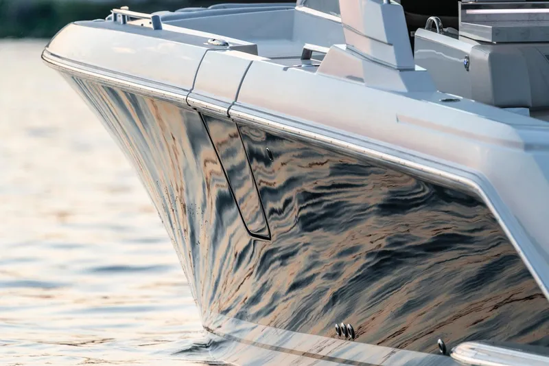 Slide: The Image of 2025 Tiara Sport 38 LS boat reflecting water at sunset. - 3