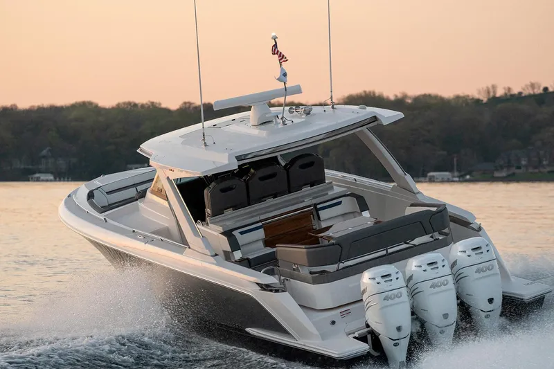 Slide: The Image of 2025 Tiara Sport 38 LS boat cruising on a lake at sunset. - 5