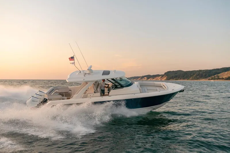 Slide: The Image of 2025 Tiara Sport 38 LS boat cruising on open water at sunset. - 6