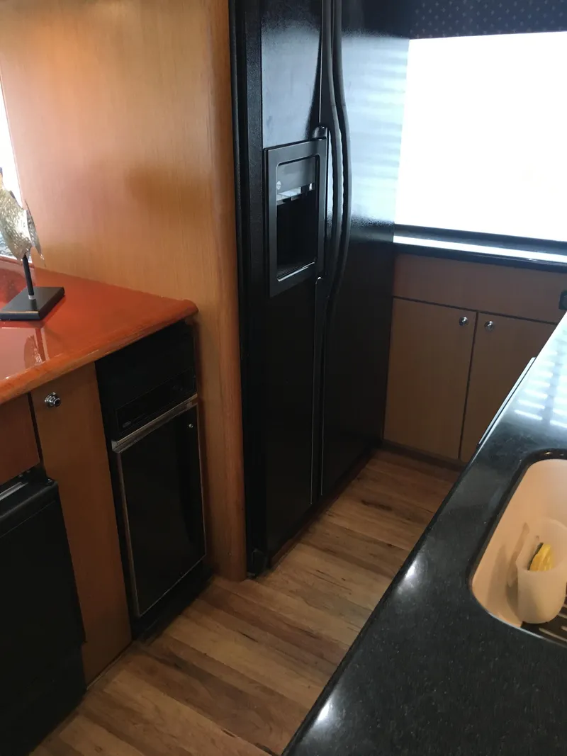 Slide: The Image of Interior kitchen view of 2001 Ocean Yachts 56 Super Sport with black appliances. - 15