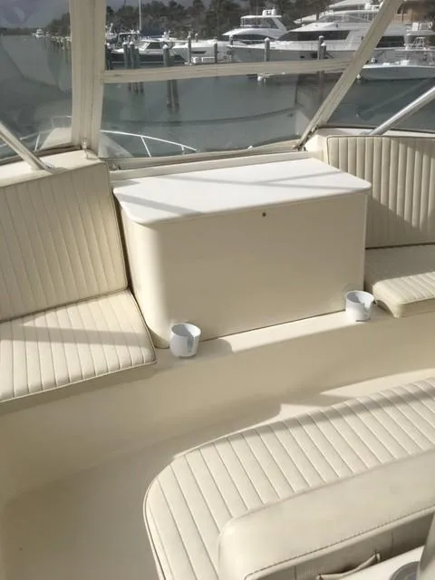 Slide: The Image of 2001 Ocean Yachts 56 Super Sport interior seating area with marina view. - 3