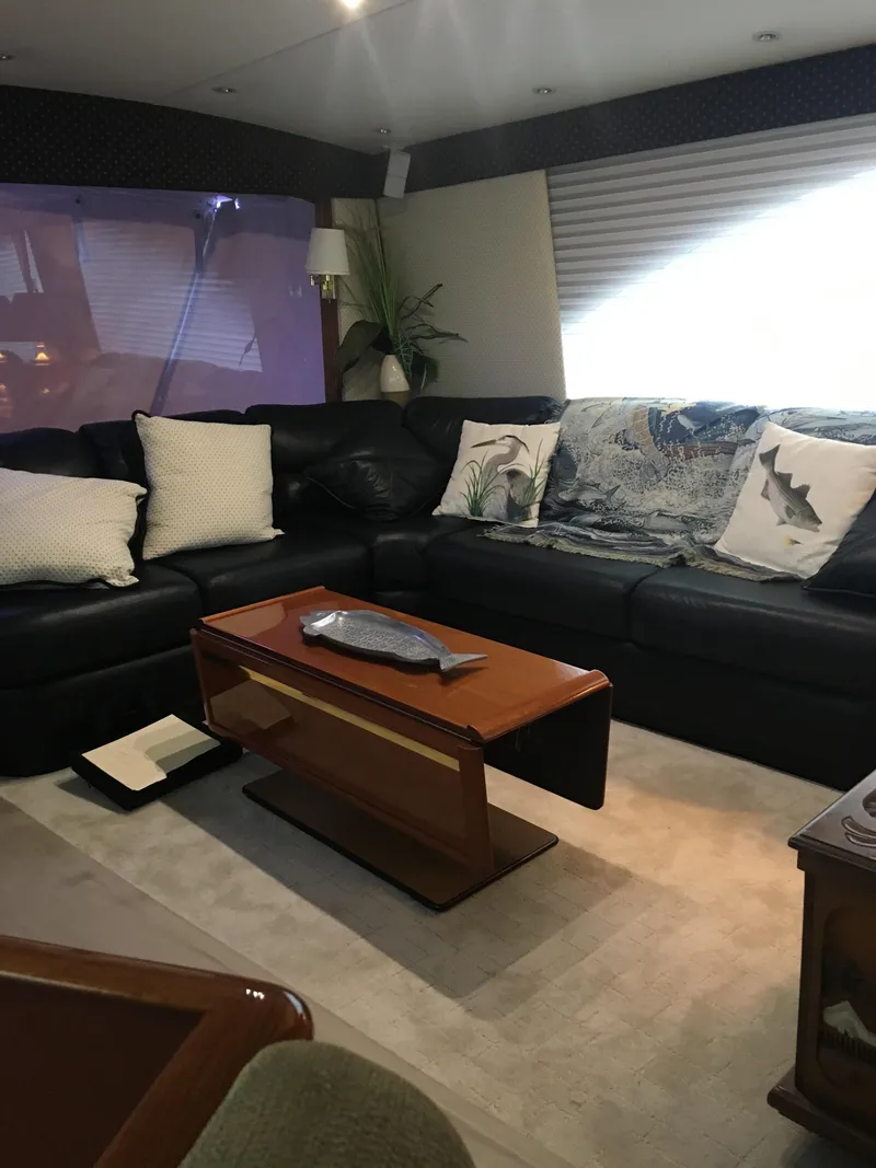 Slide: The Image of Luxurious interior of 2001 Ocean Yachts 56 Super Sport with leather seating and wooden table. - 33