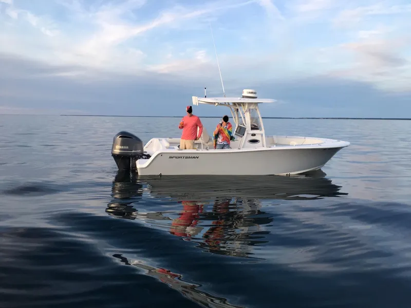Slide: The Image of 2018 Sportsman 242 Open boat on calm water with two people fishing. - 0