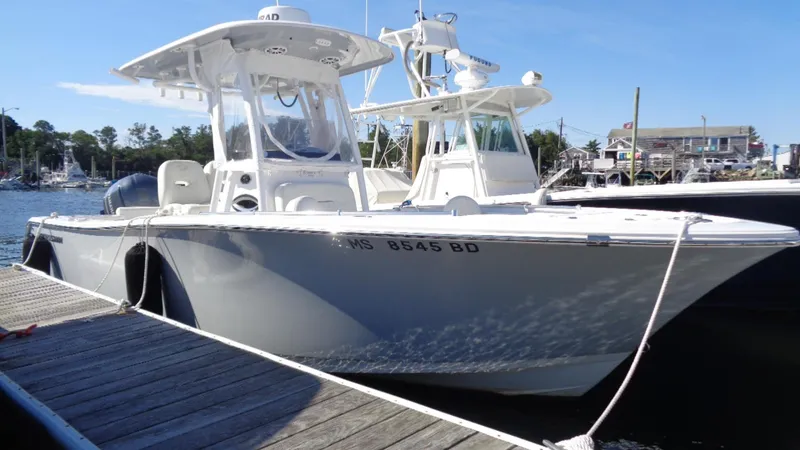 Slide: The Image of 2018 Sportsman 242 Open boat docked at marina under clear blue sky. - 1