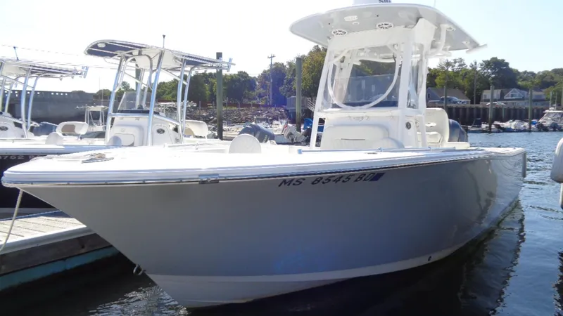 Slide: The Image of 2018 Sportsman 242 Open boat docked in a marina, showcasing sleek design and modern features. - 2