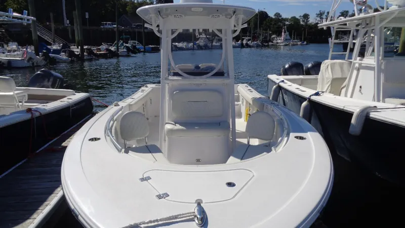 Slide: The Image of 2018 Sportsman 242 Open boat docked at marina, featuring sleek design and spacious deck. - 3