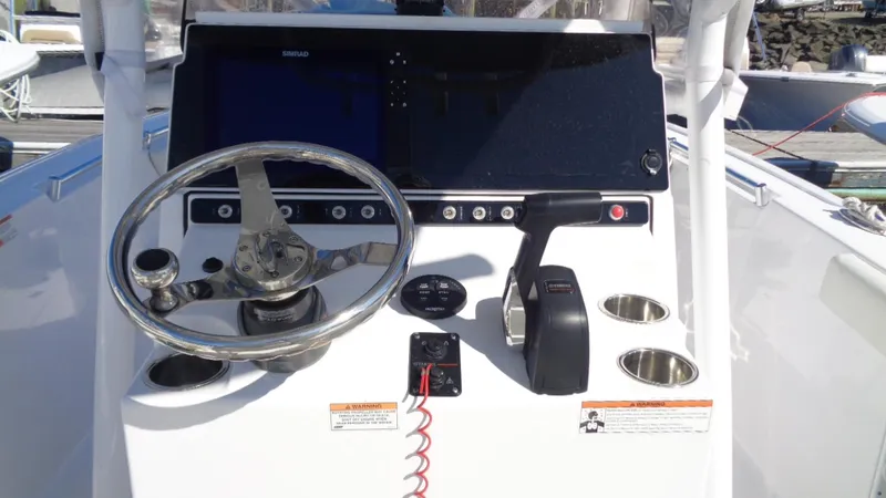 Slide: The Image of 2018 Sportsman 242 Open boat dashboard with steering wheel and controls. - 5