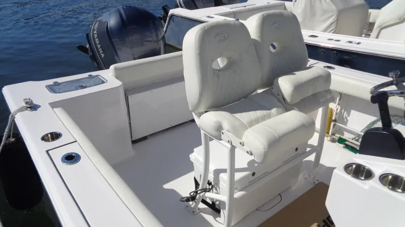Slide: The Image of 2018 Sportsman 242 Open boat interior with white seating and dual outboard motors. - 6