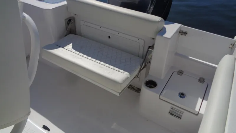 Slide: The Image of 2018 Sportsman 242 Open boat interior with white seating and storage compartments. - 8