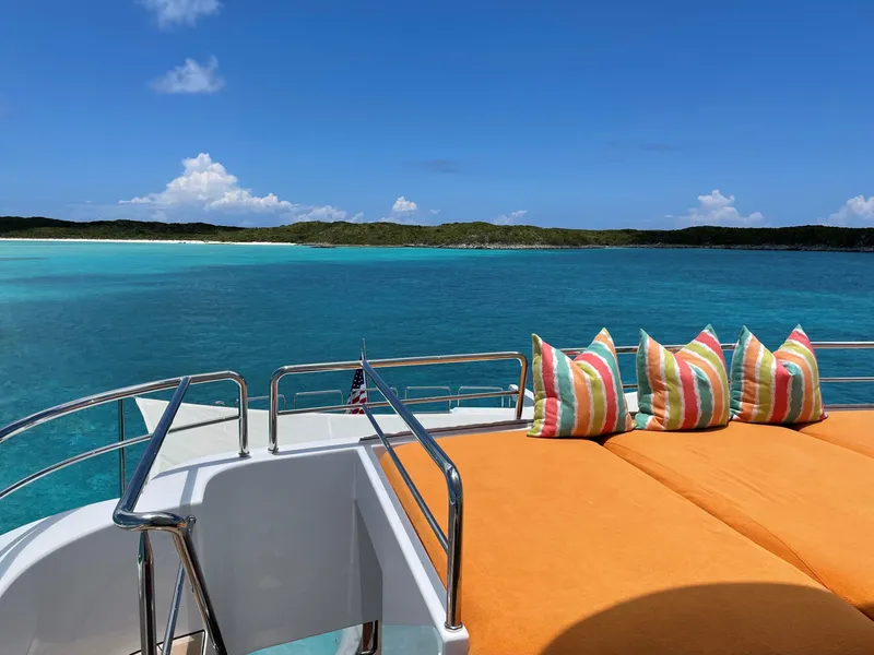 Slide: The Image of Westport Tri-Deck Motoryacht 2006 with sun deck and cushions, overlooking tropical sea. - 12