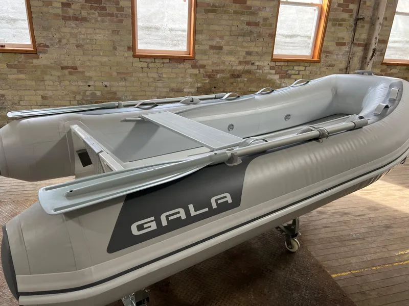 Slide: The Image of 2023 Gala A300 Ultra Lite inflatable boat in a warehouse setting. - 0