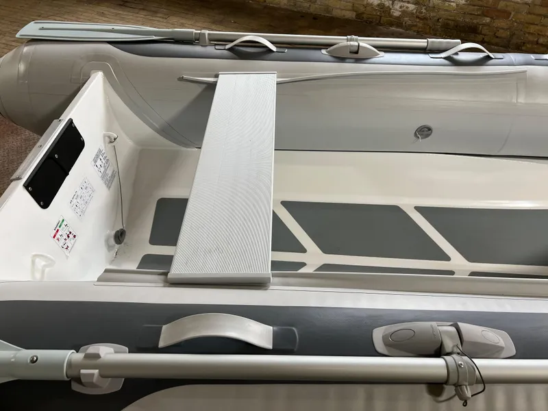 Slide: The Image of 2023 Gala A300 Ultra Lite inflatable boat interior with bench seat and oars. - 4