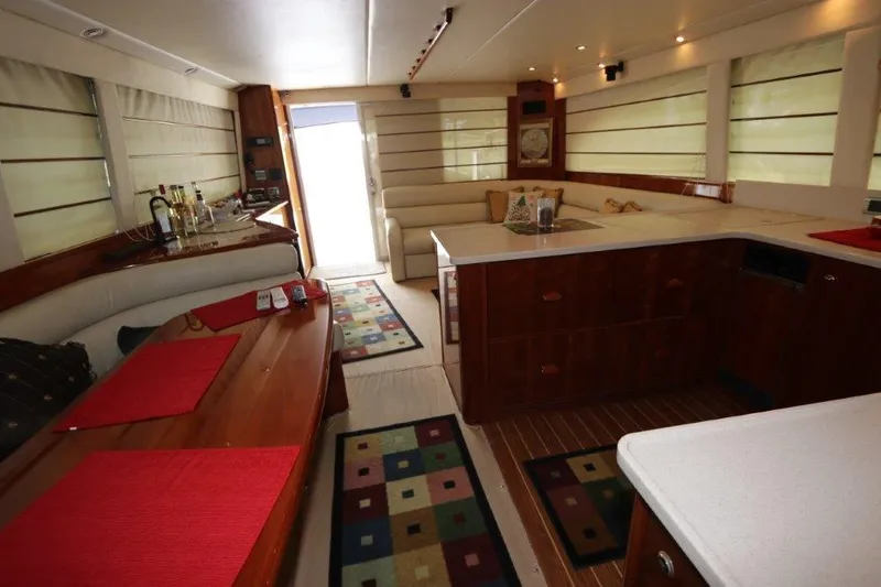 Slide: The Image of Interior of 2004 Riviera 58 Enclosed Flybridge yacht with modern kitchen and seating area. - 11
