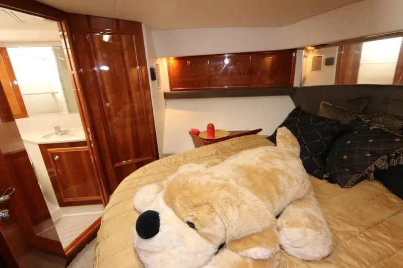 Slide: The Image of Luxurious bedroom in 2004 Riviera 58 Enclosed Flybridge yacht with plush dog toy. - 13