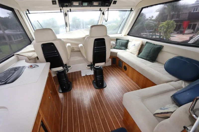 Slide: The Image of Interior of 2004 Riviera 58 Enclosed Flybridge with seating and helm station. - 26