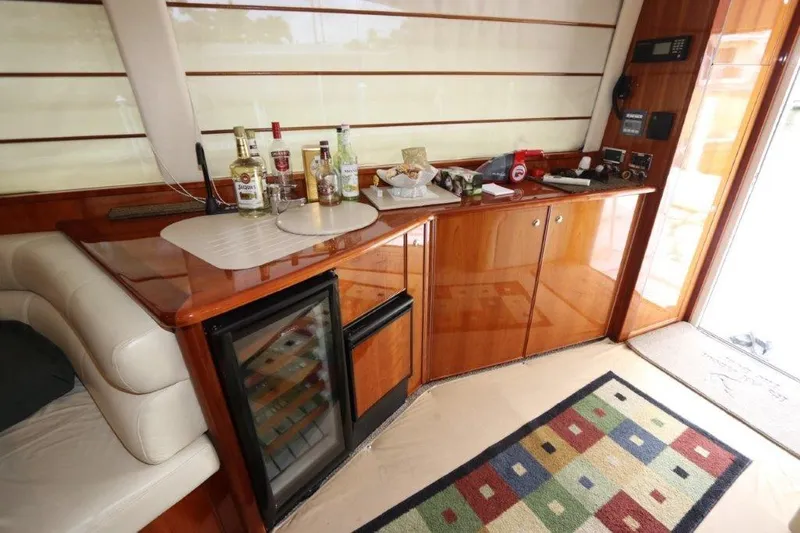 Slide: The Image of Luxurious interior of 2004 Riviera 58 Enclosed Flybridge with bar and mini-fridge. - 7