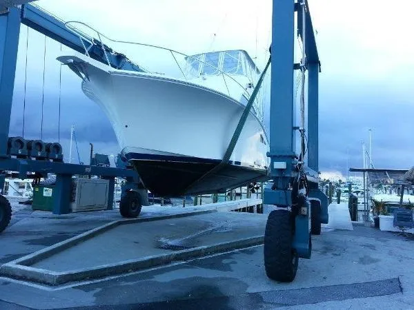 Slide: The Image of 2008 Luhrs 35C boat lifted on a marina dock. - 11