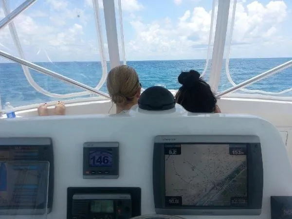Slide: The Image of View from the helm of a 2008 Luhrs 35C boat with two people enjoying the ocean. - 14